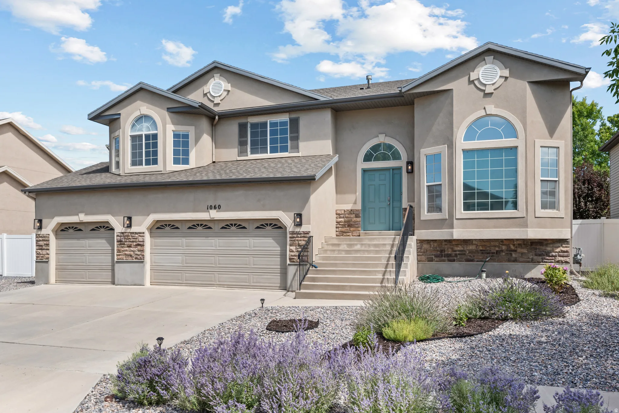 Stucco exterior with stone accents and arched windows