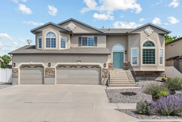 Stucco exterior with stone accents and a two-car garage