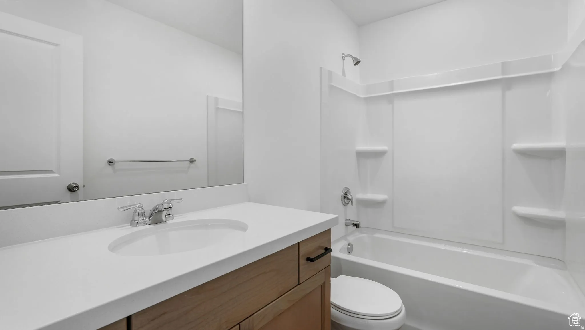 Bathroom featuring a single vanity with wood-finish cabinetry, a white countertop, and an integrated sink