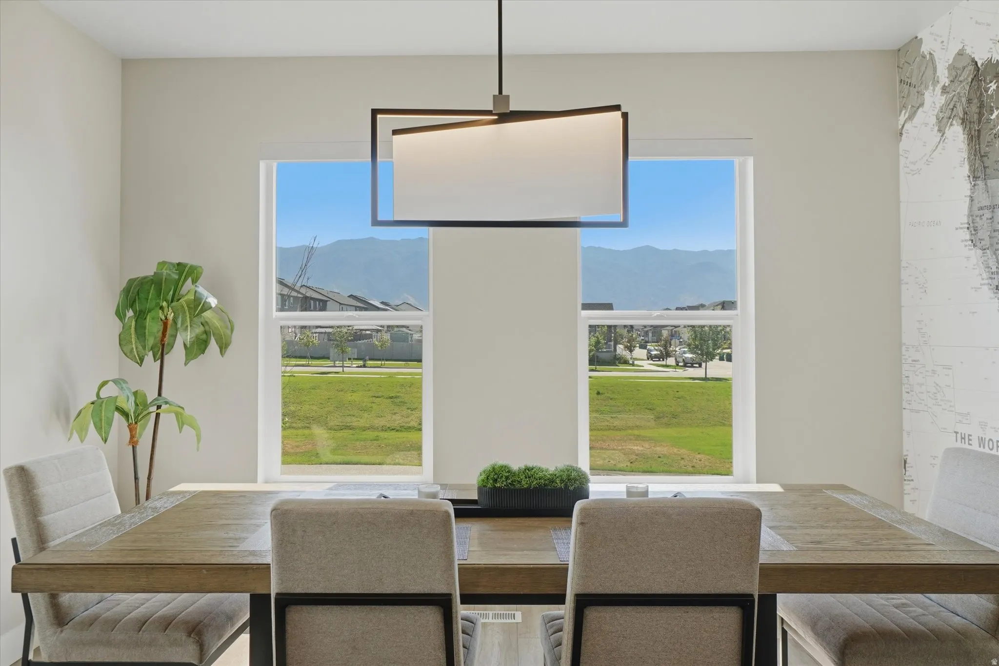 Spacious dining area featuring a modern rectangular chandelier