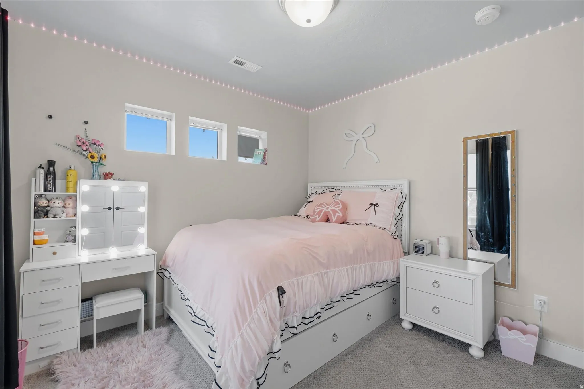 Bedroom featuring light grey carpeting, recessed lighting, and a ceiling light fixture
