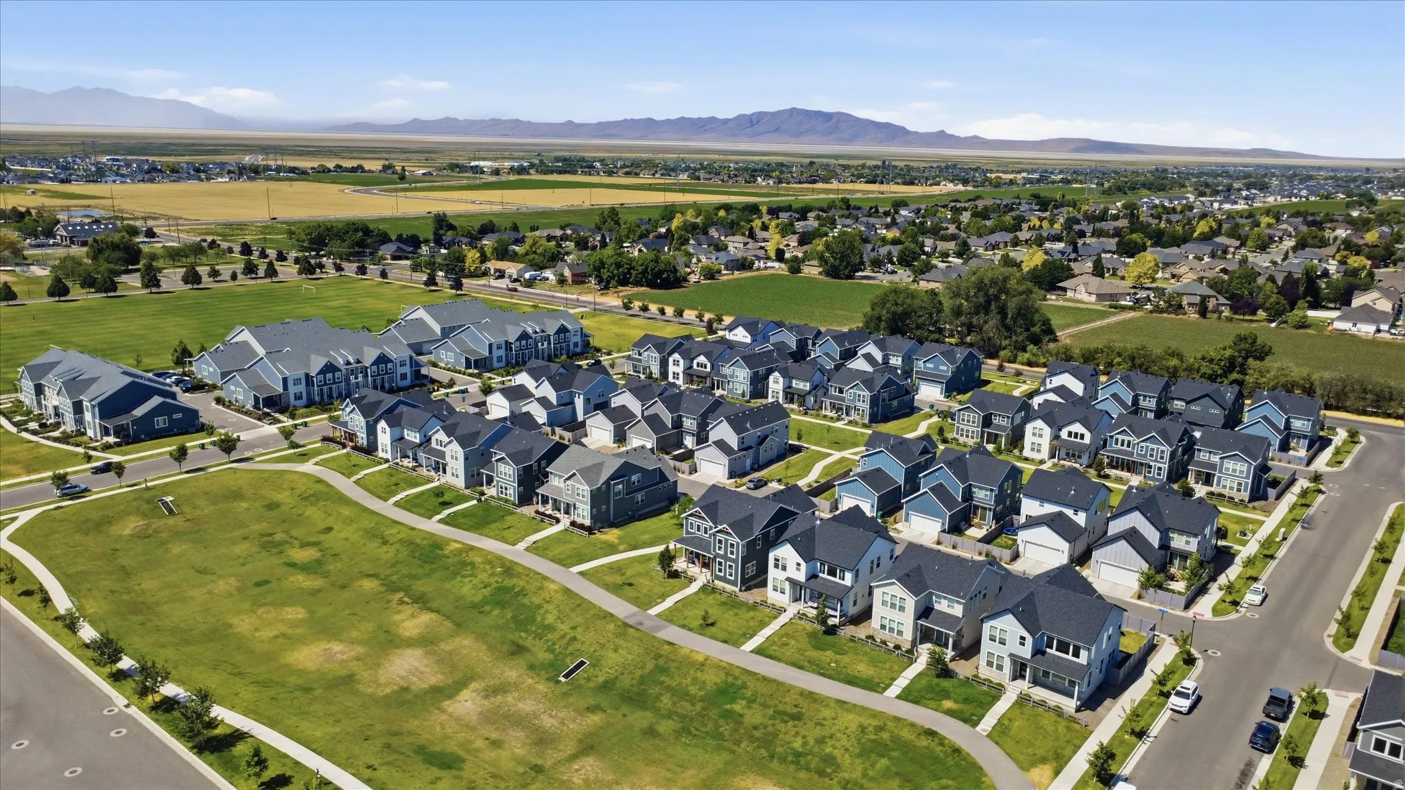 Newly constructed residential development featuring a collection of detached homes and multi-family buildings
