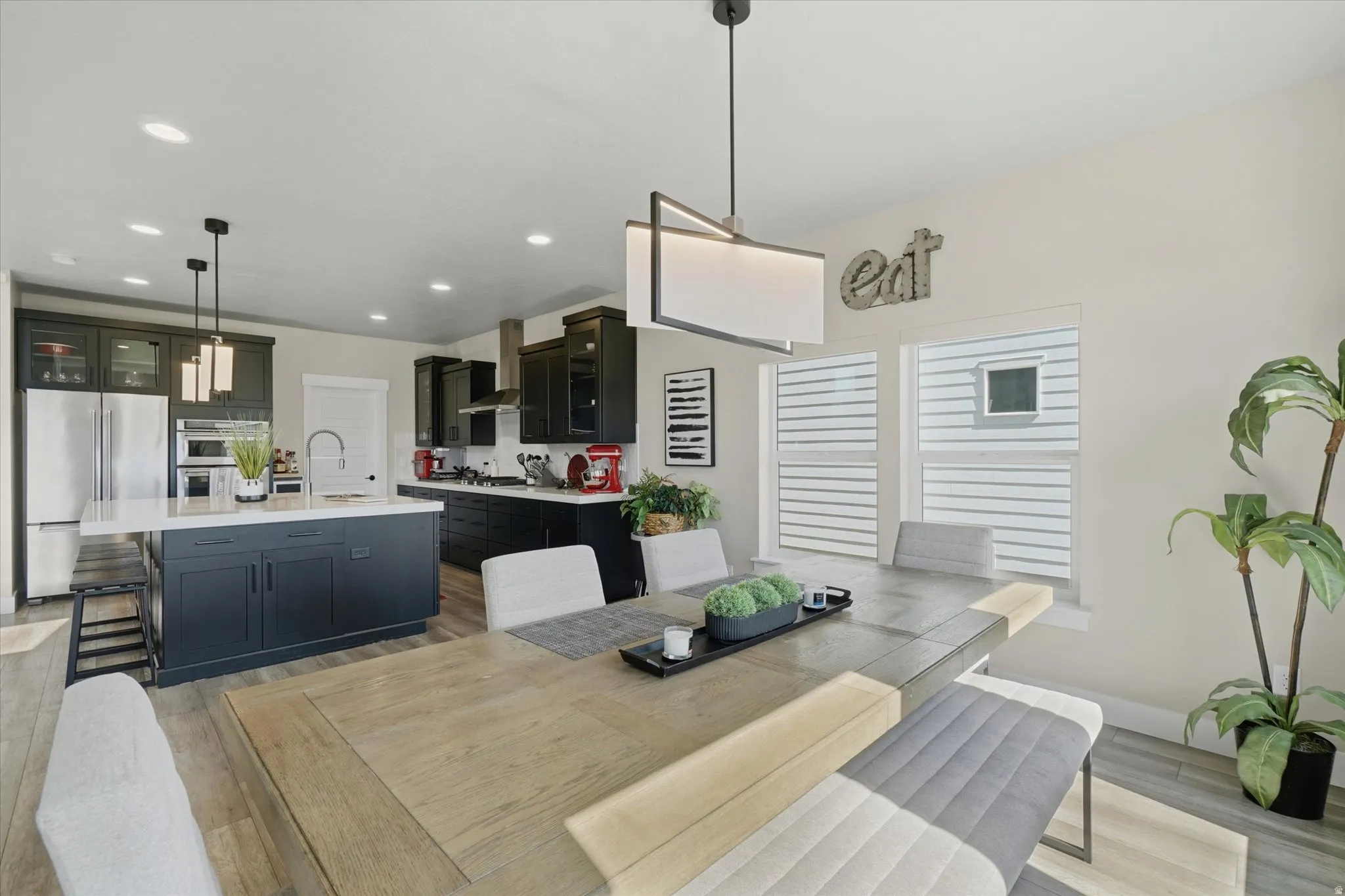 Open-concept kitchen and dining area featuring light wood-finish flooring