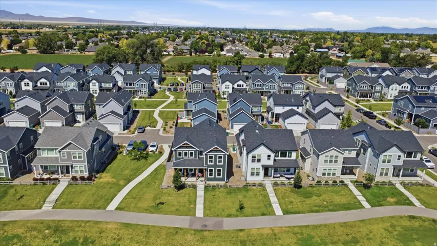 Contemporary residential development featuring a collection of two-story homes with varied exterior siding and dark-shingle roofing