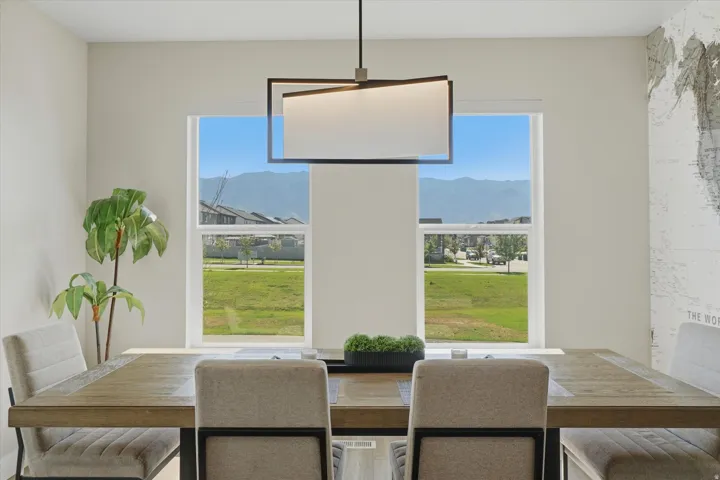 Spacious dining area featuring a modern rectangular chandelier
