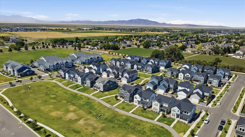 Newly constructed residential development featuring a collection of detached homes and multi-family buildings