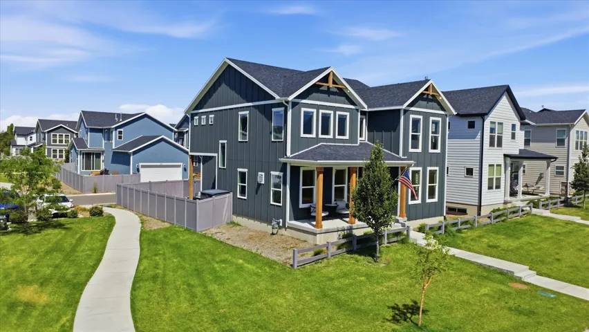 Modern two-story residence featuring dark vertical siding and white trim