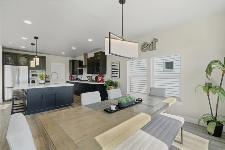 Open-concept kitchen and dining area featuring light wood-finish flooring