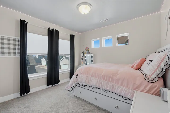 Carpeted room featuring multiple windows including a large picture window and three transom windows