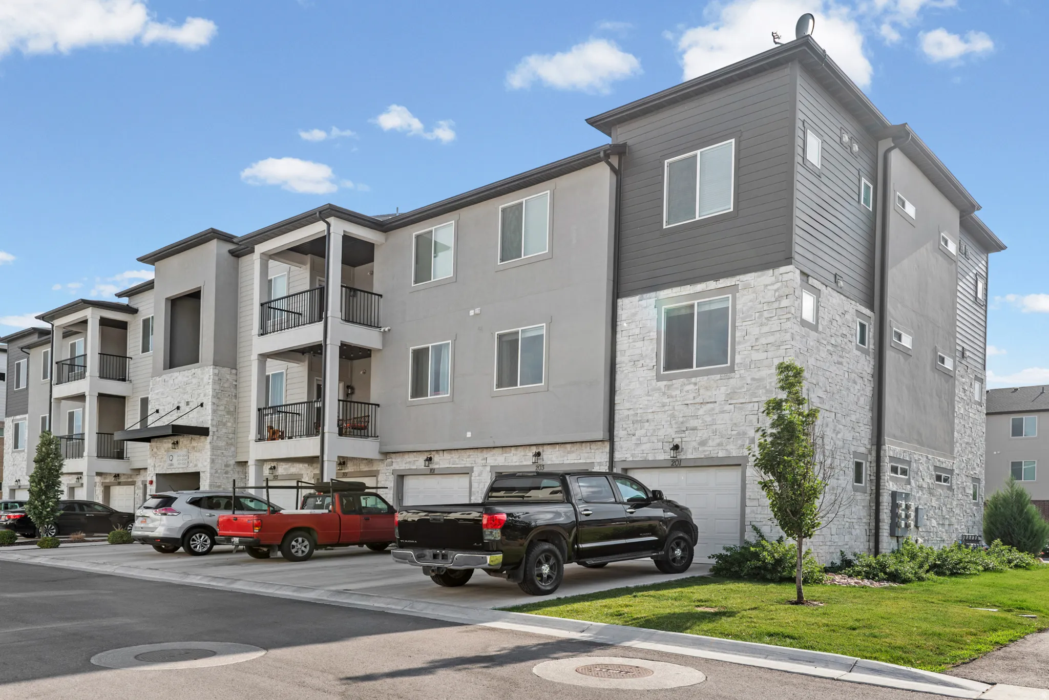 Contemporary multi-story building featuring stucco and stone veneer siding
