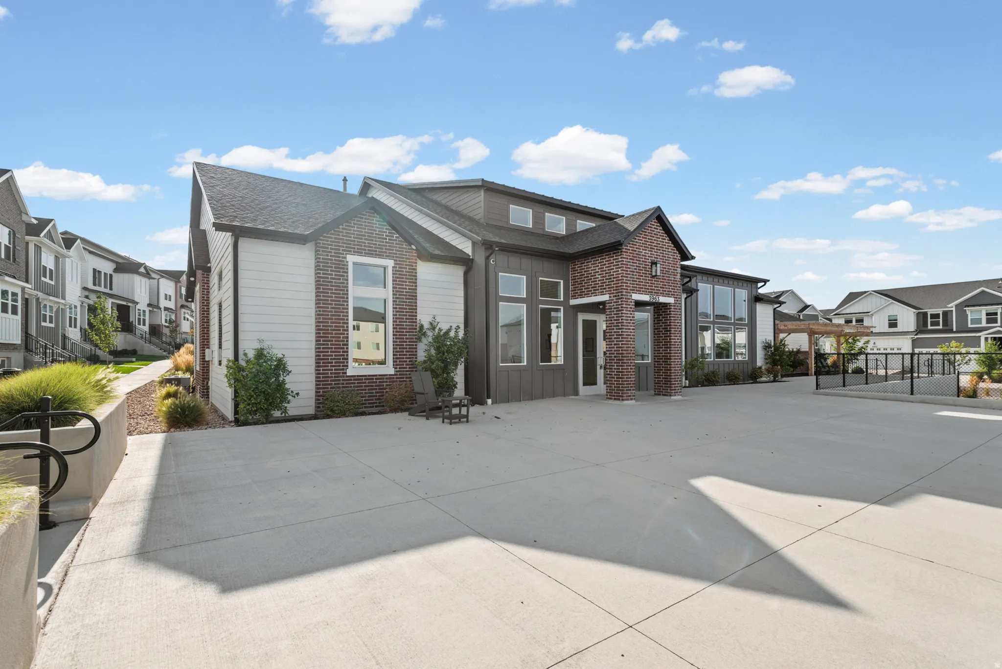 Modern building exterior featuring a mixed material facade of brick, vertical siding, and horizontal siding