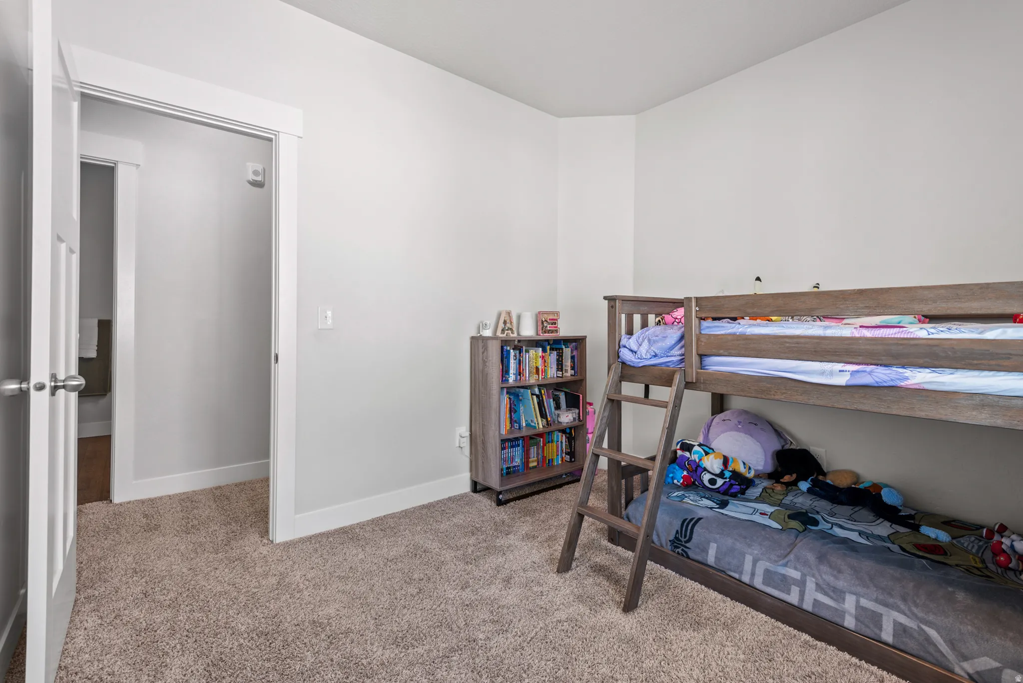 Carpeted room featuring light gray walls and white trim
