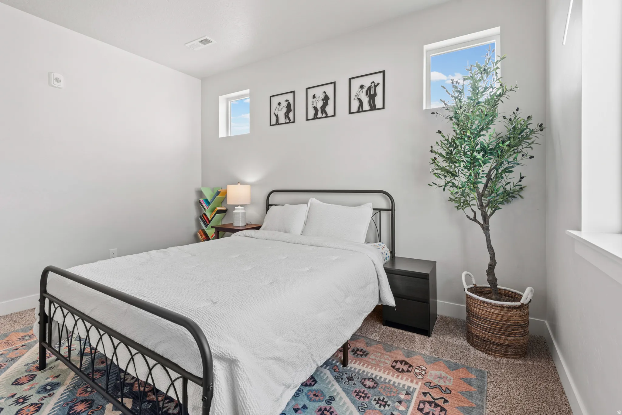 Bright room featuring two transom windows, light neutral wall paint, and carpeted flooring