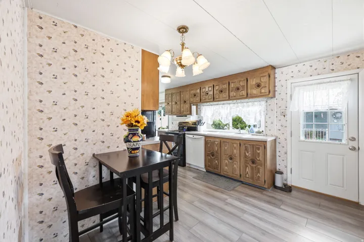 Kitchen featuring wood-finish cabinetry, white countertops, built-in sink, and a multi-pane exterior door
