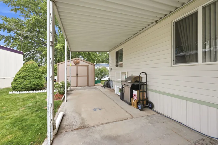 Covered patio area with concrete flooring, offering sheltered outdoor living space