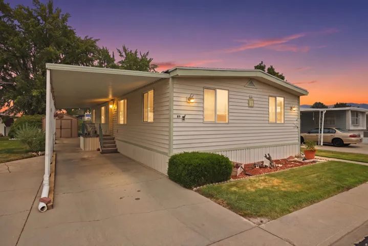 Single-story manufactured home featuring horizontal siding and a covered carport
