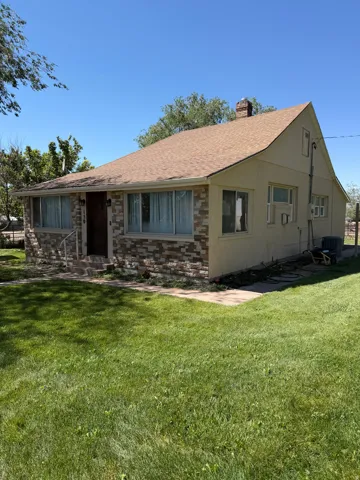 Exterior featuring a textured stone facade and tan siding