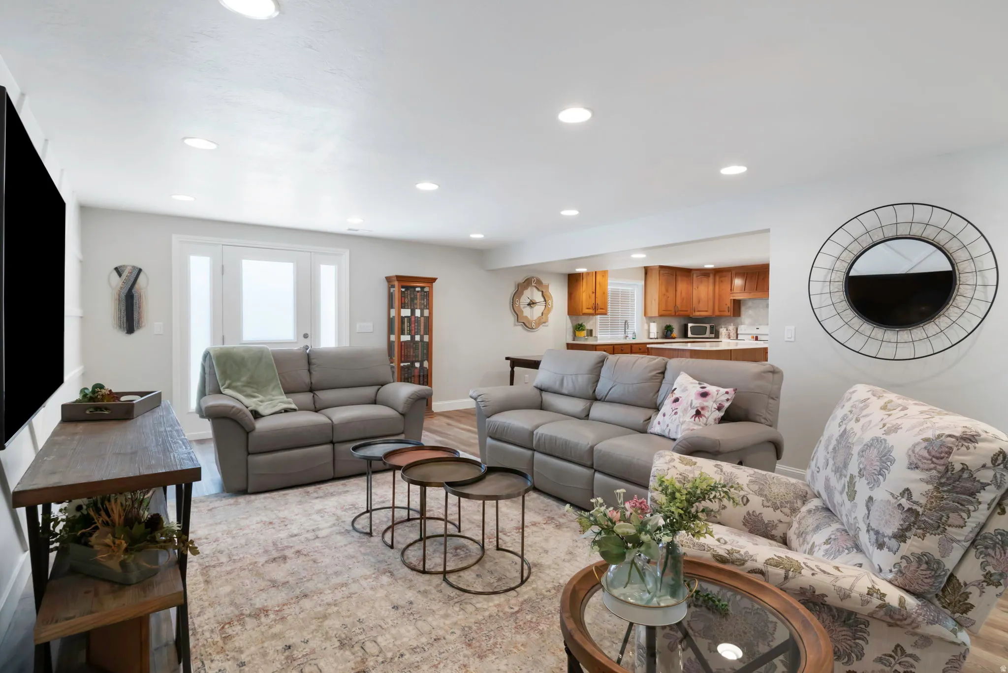 Open concept living space featuring recessed lighting and wood-finish flooring