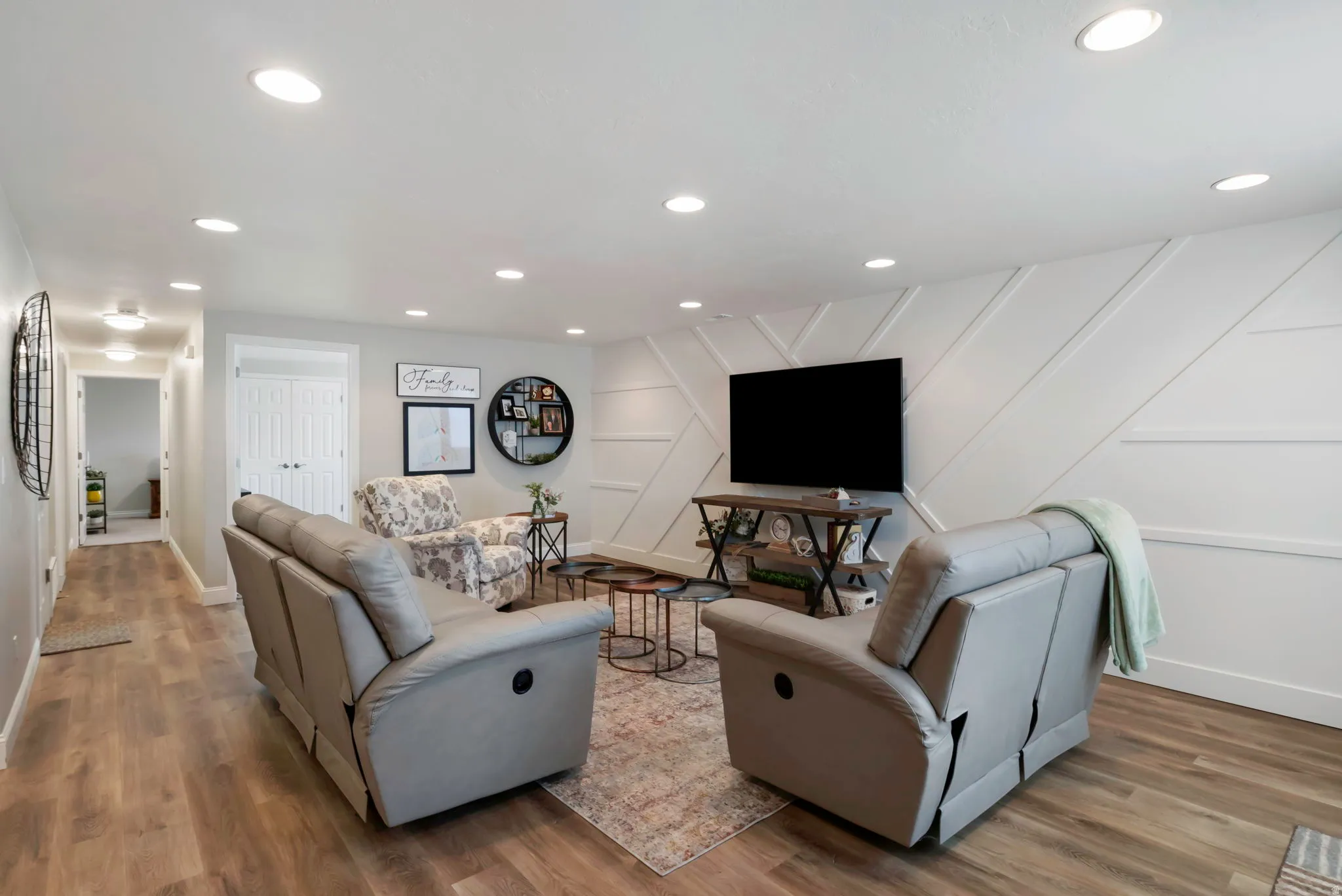Living area featuring wood-finish flooring and recessed ceiling lighting