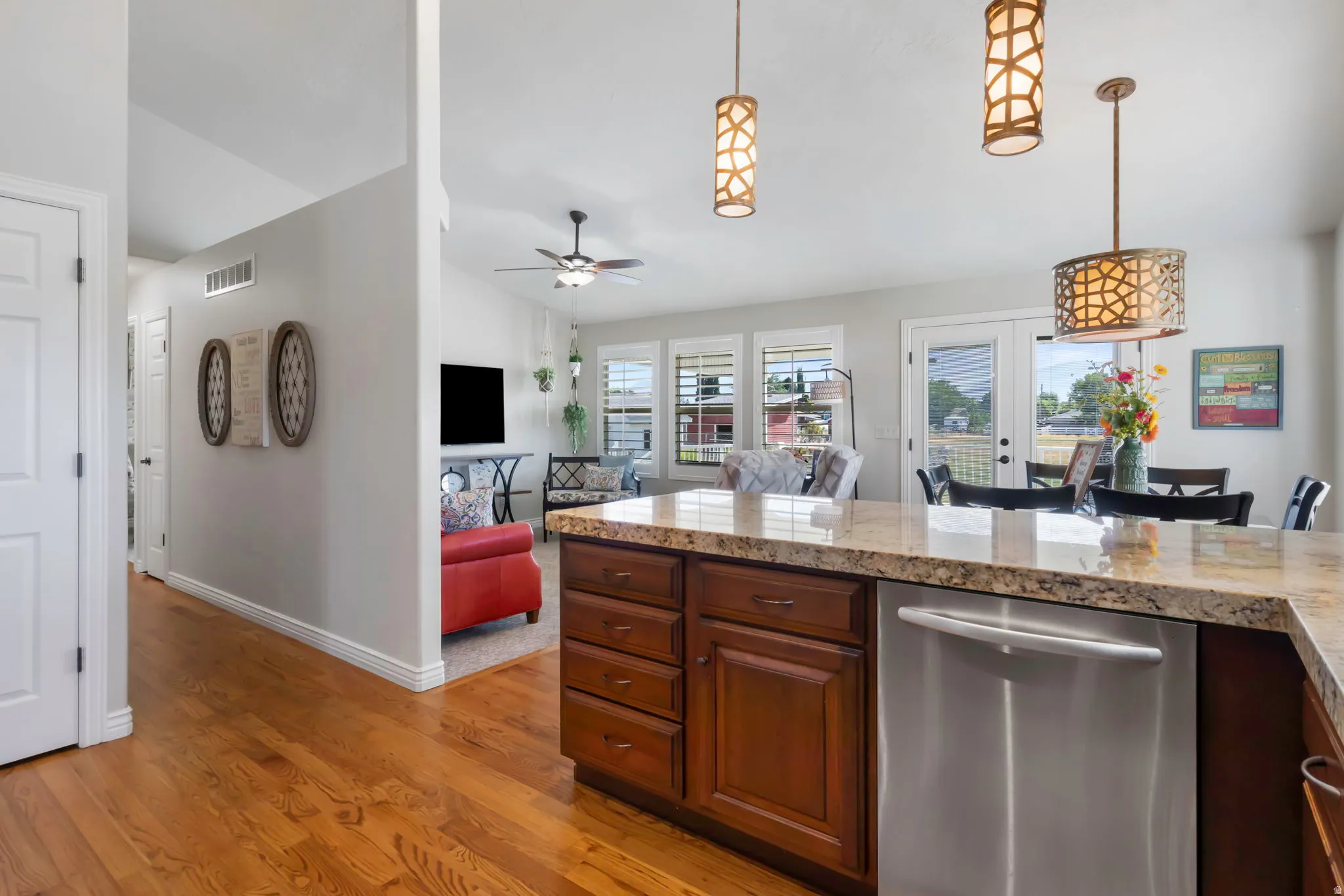 Kitchen island with stone countertop and integrated stainless steel dishwasher