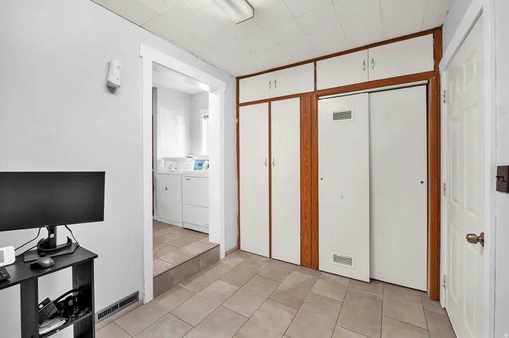 Built-in cabinetry with white doors and wood trim provides storage solutions
