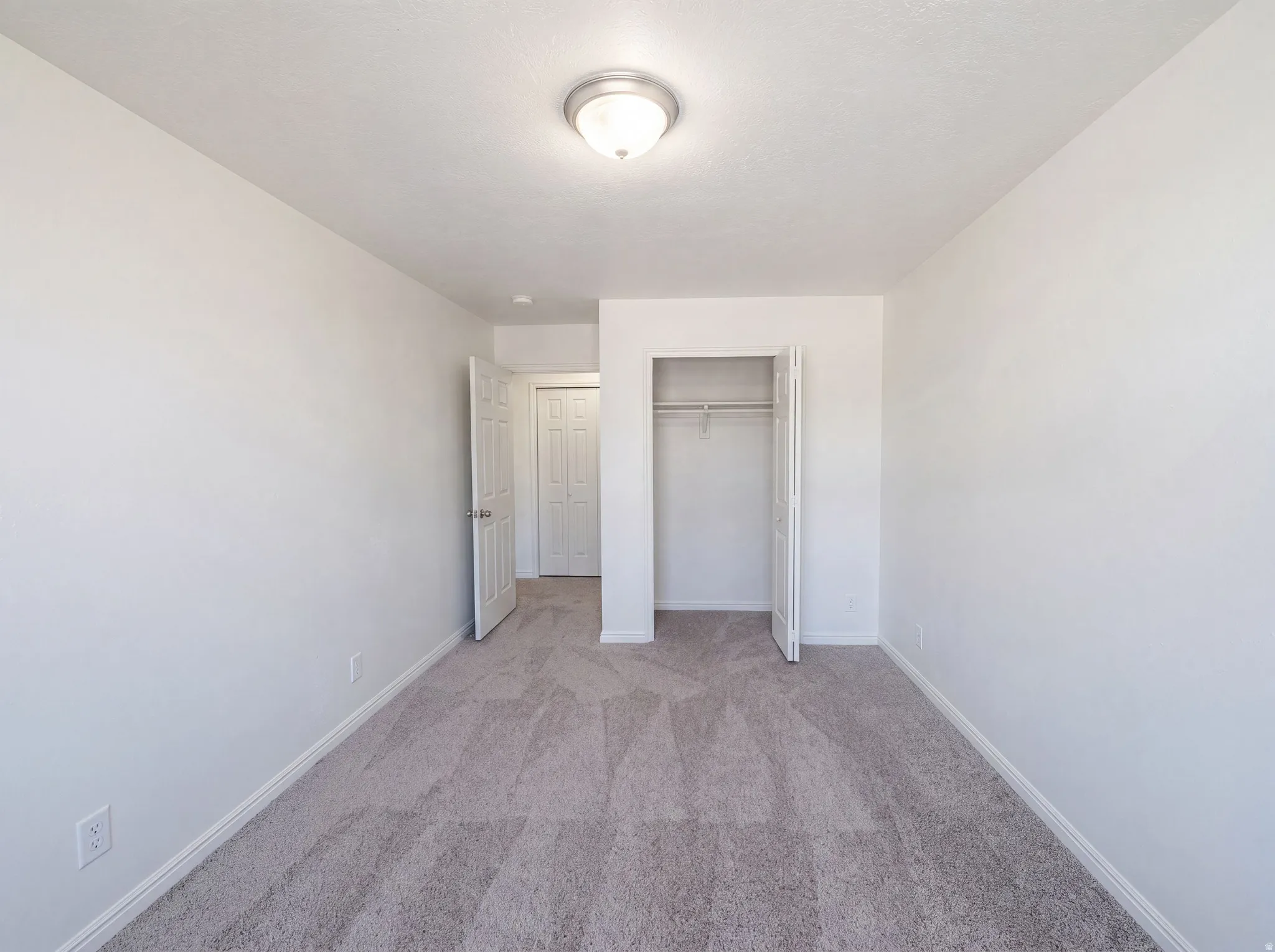 Neutral toned wall-to-wall carpeting in a bright interior space