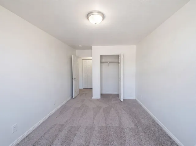 Neutral toned wall-to-wall carpeting in a bright interior space