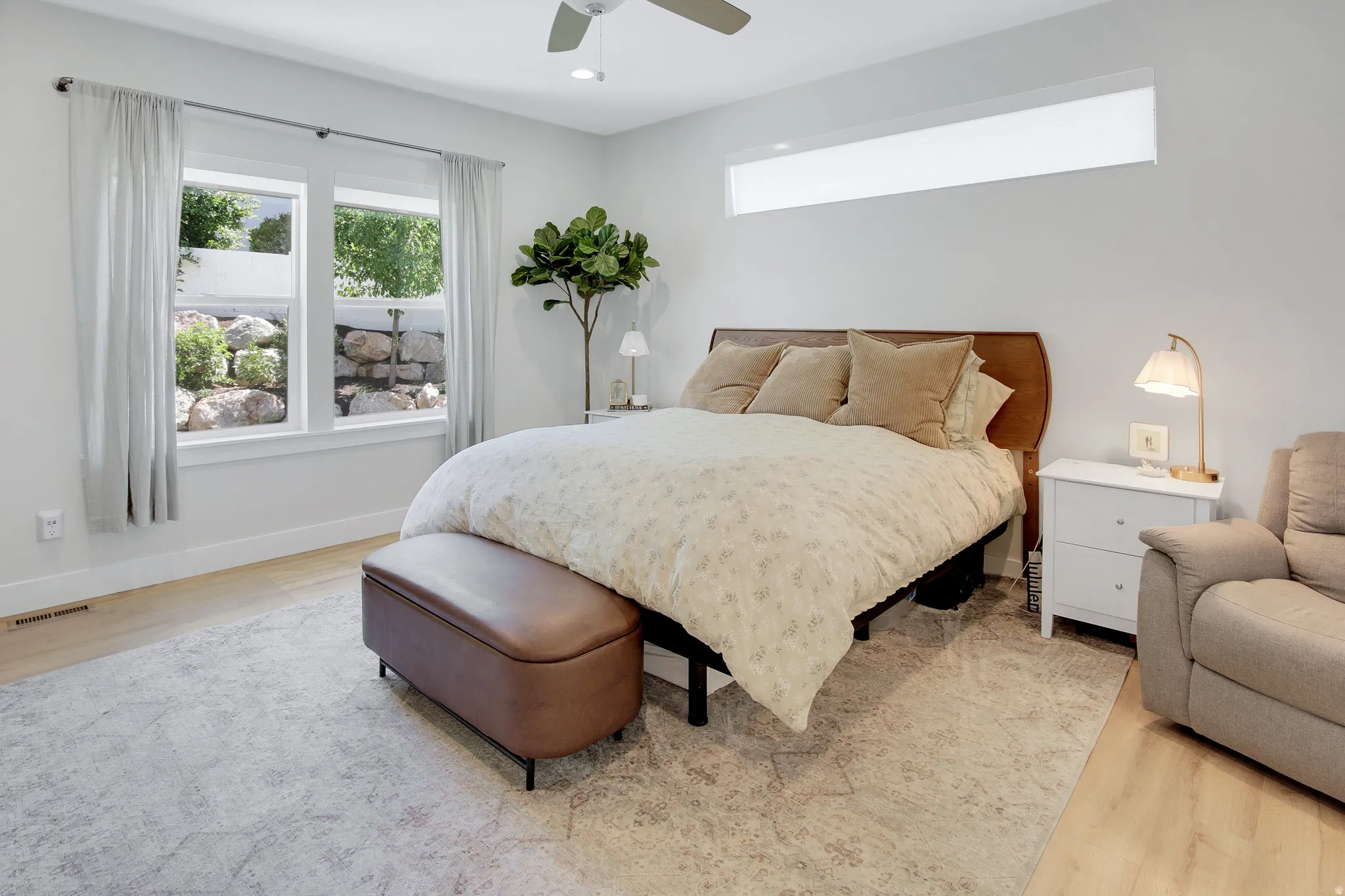 Spacious room featuring wood-finish flooring, a contemporary ceiling fan, and recessed lighting