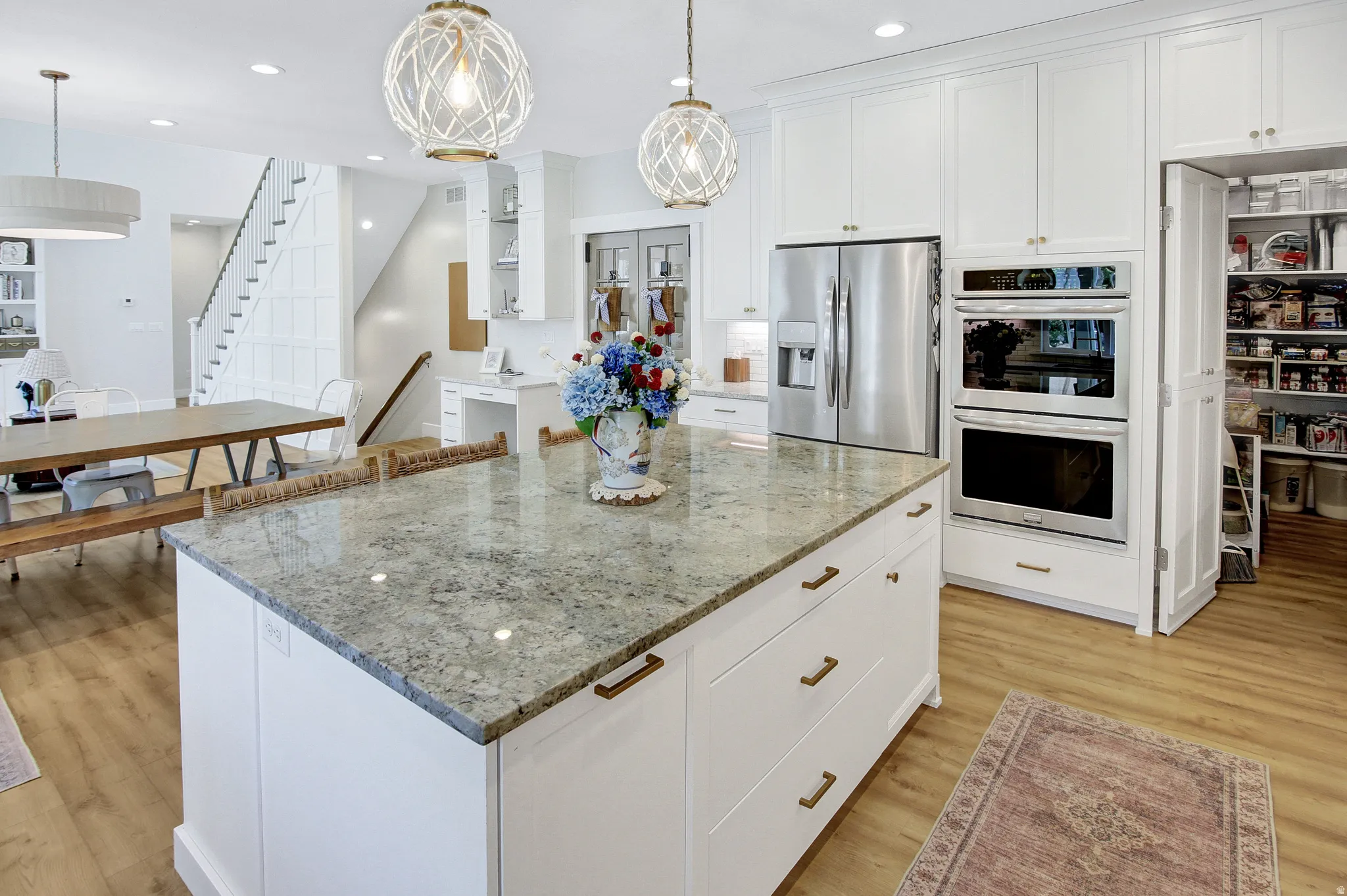 Spacious kitchen island featuring a stone countertop