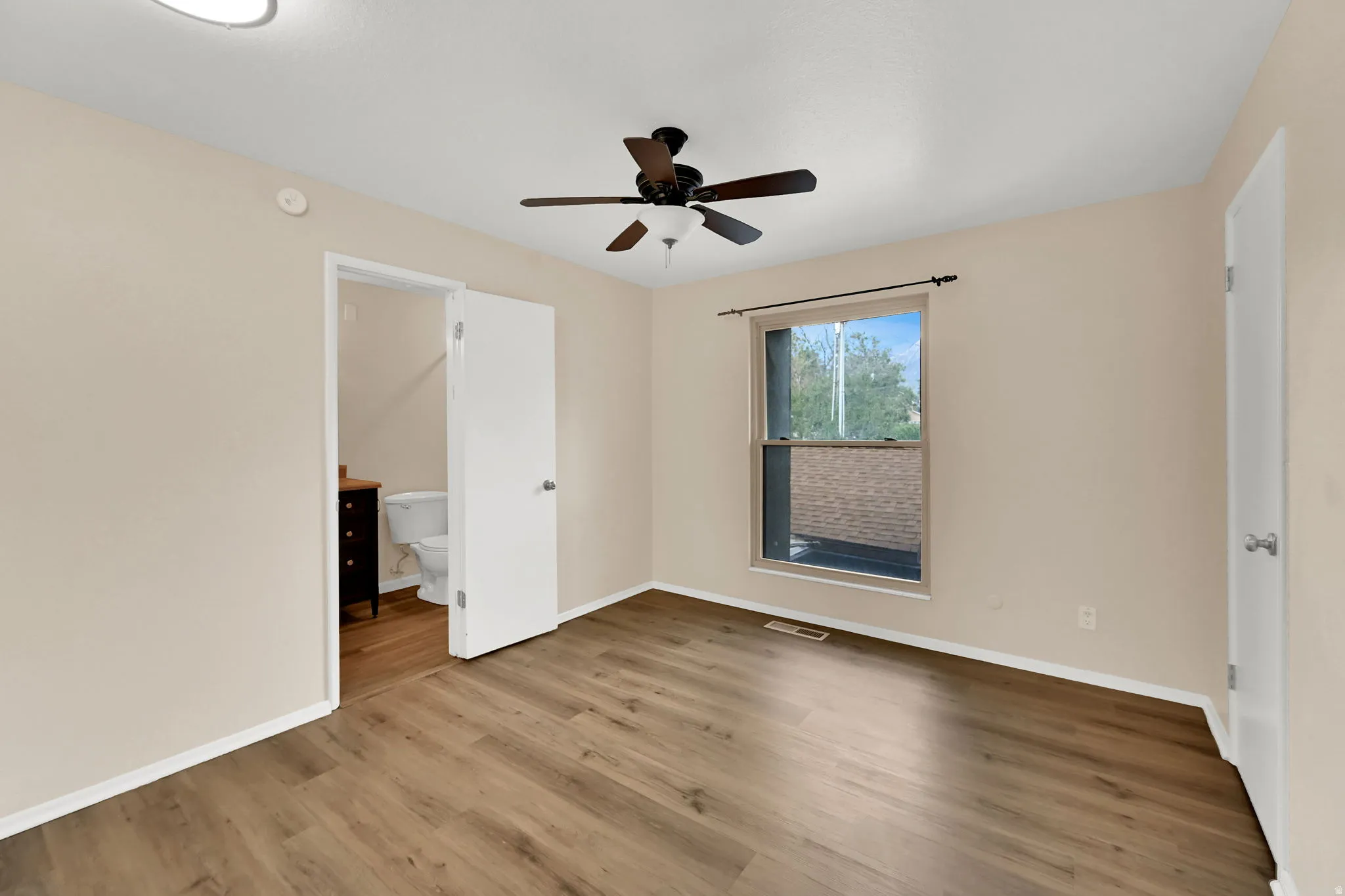 Neutral tone wall paint with wood-finish flooring