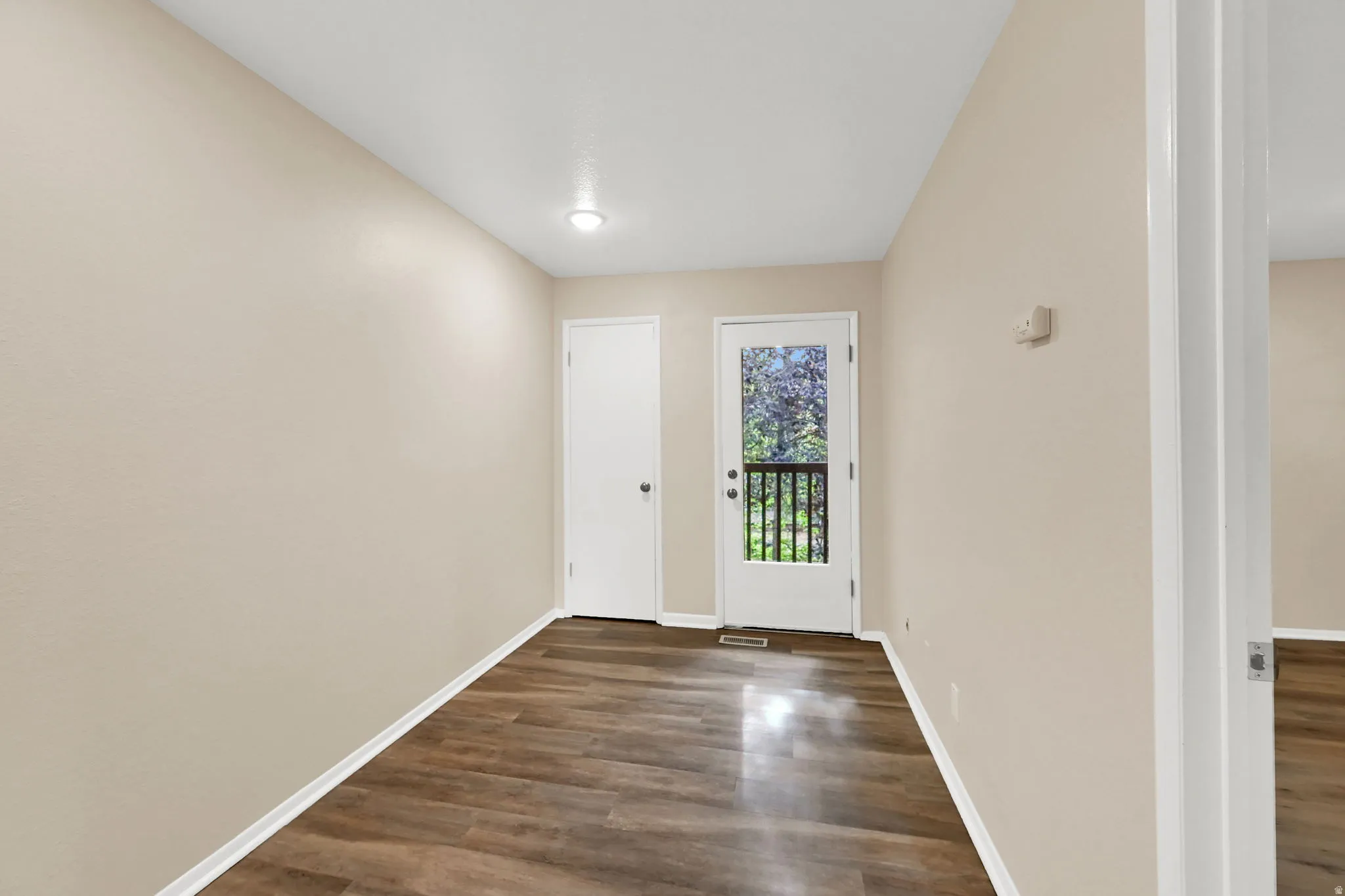 Interior space featuring wood-finish flooring, light neutral wall tones, and recessed lighting