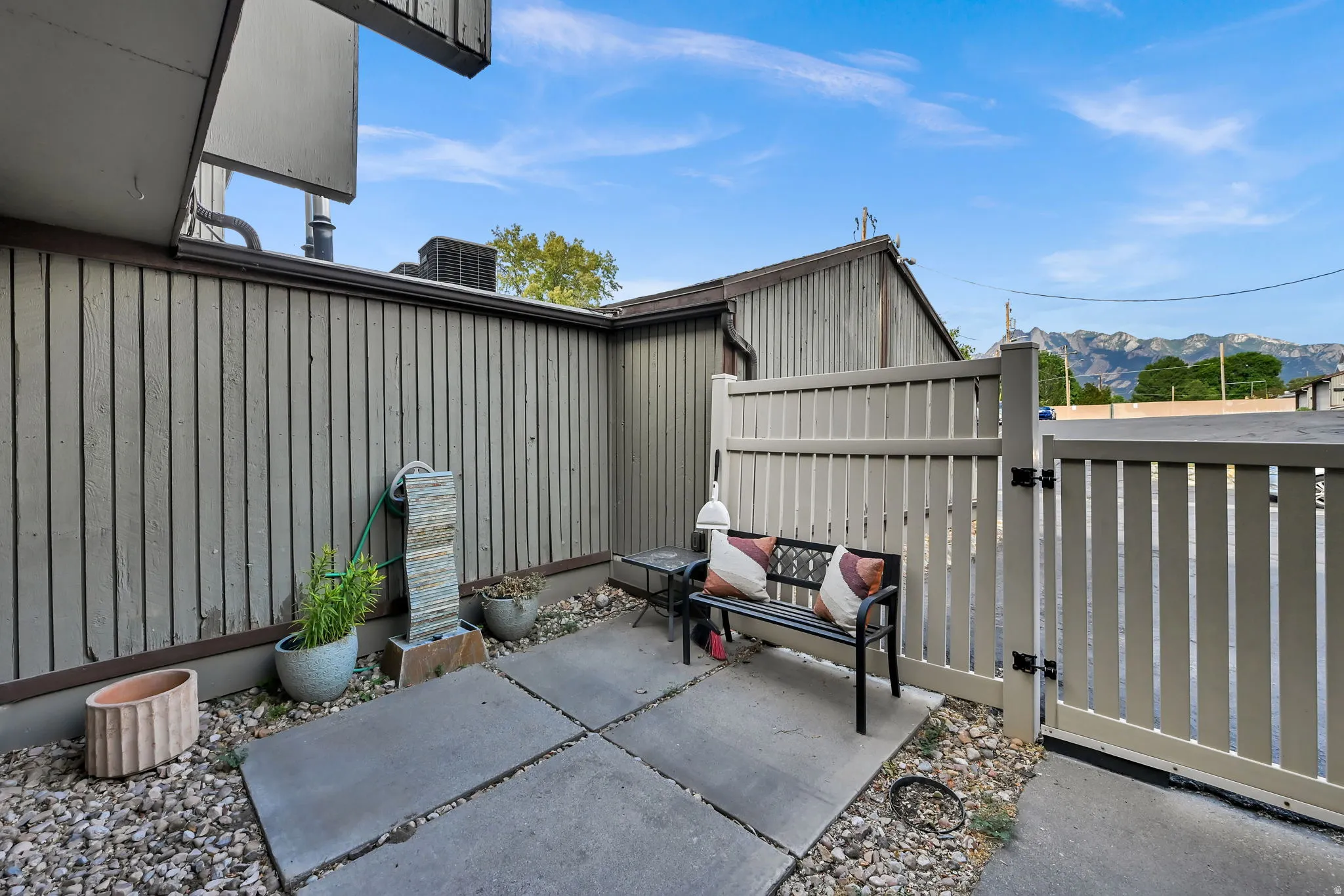 Private patio space featuring concrete pavers and a decorative fountain