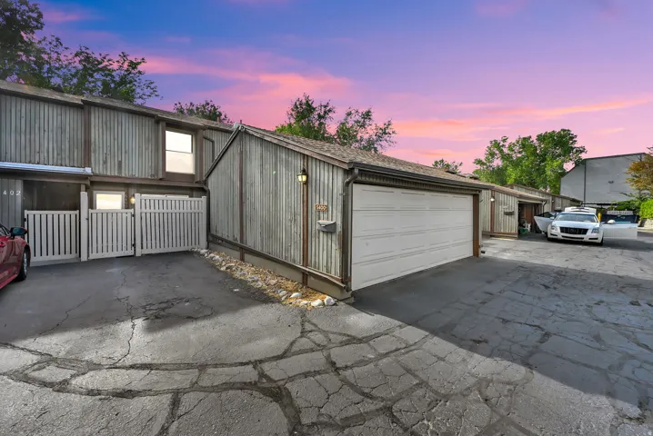 Attached garage with a white panel door