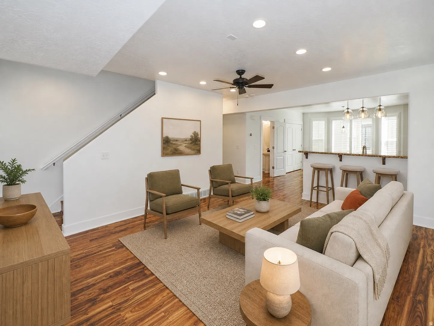 Open concept living area featuring wood-finish flooring, recessed lighting, and a ceiling fan