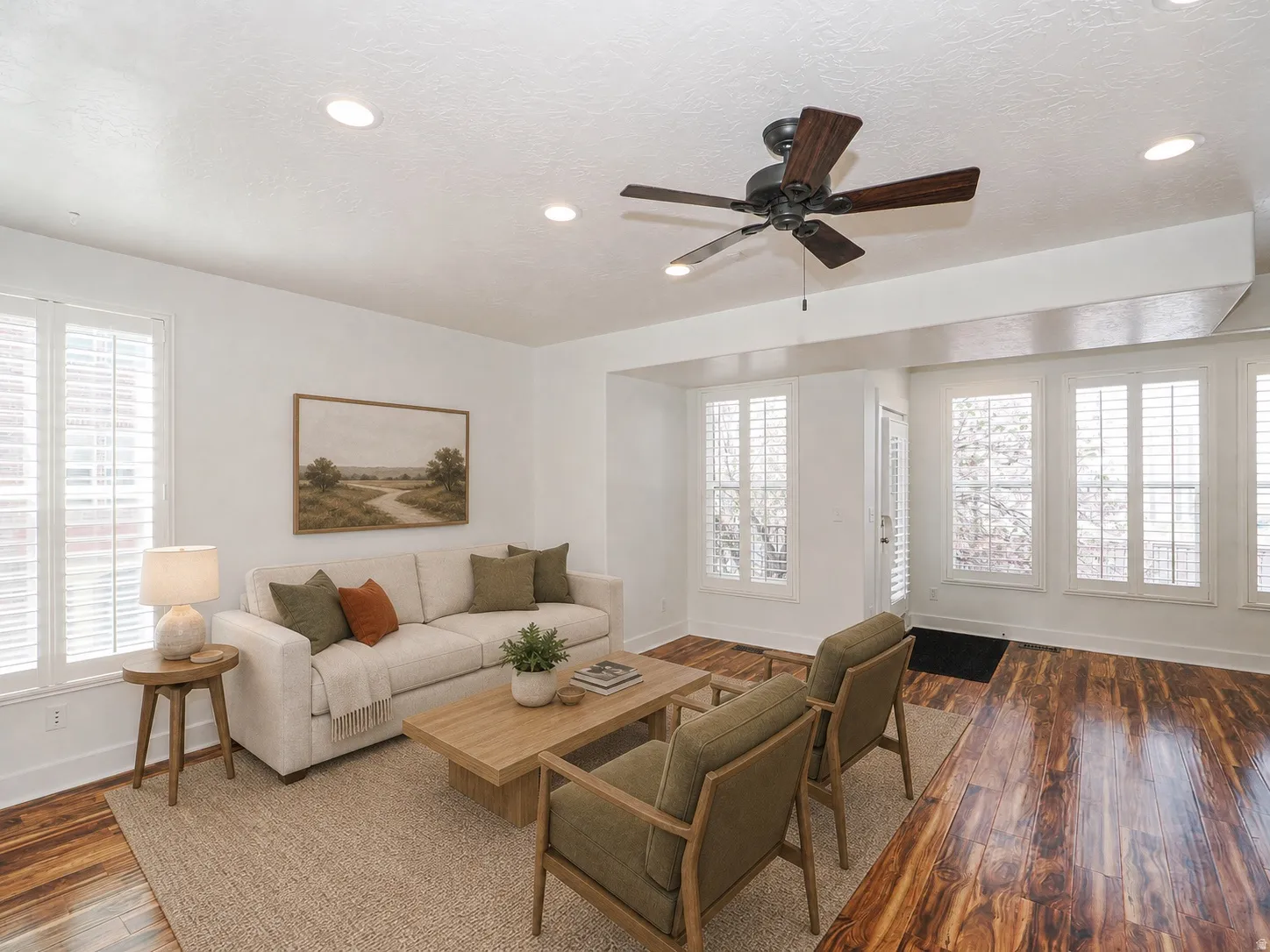Living area featuring rich wood-finish flooring and recessed lighting