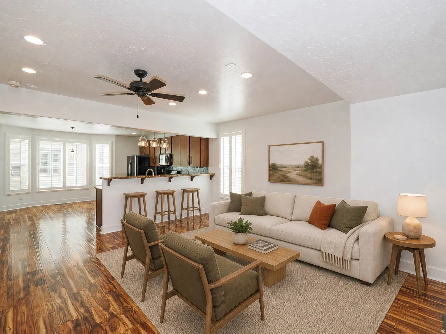 Open-concept living area featuring wood-finish flooring, recessed lighting, and a ceiling fan