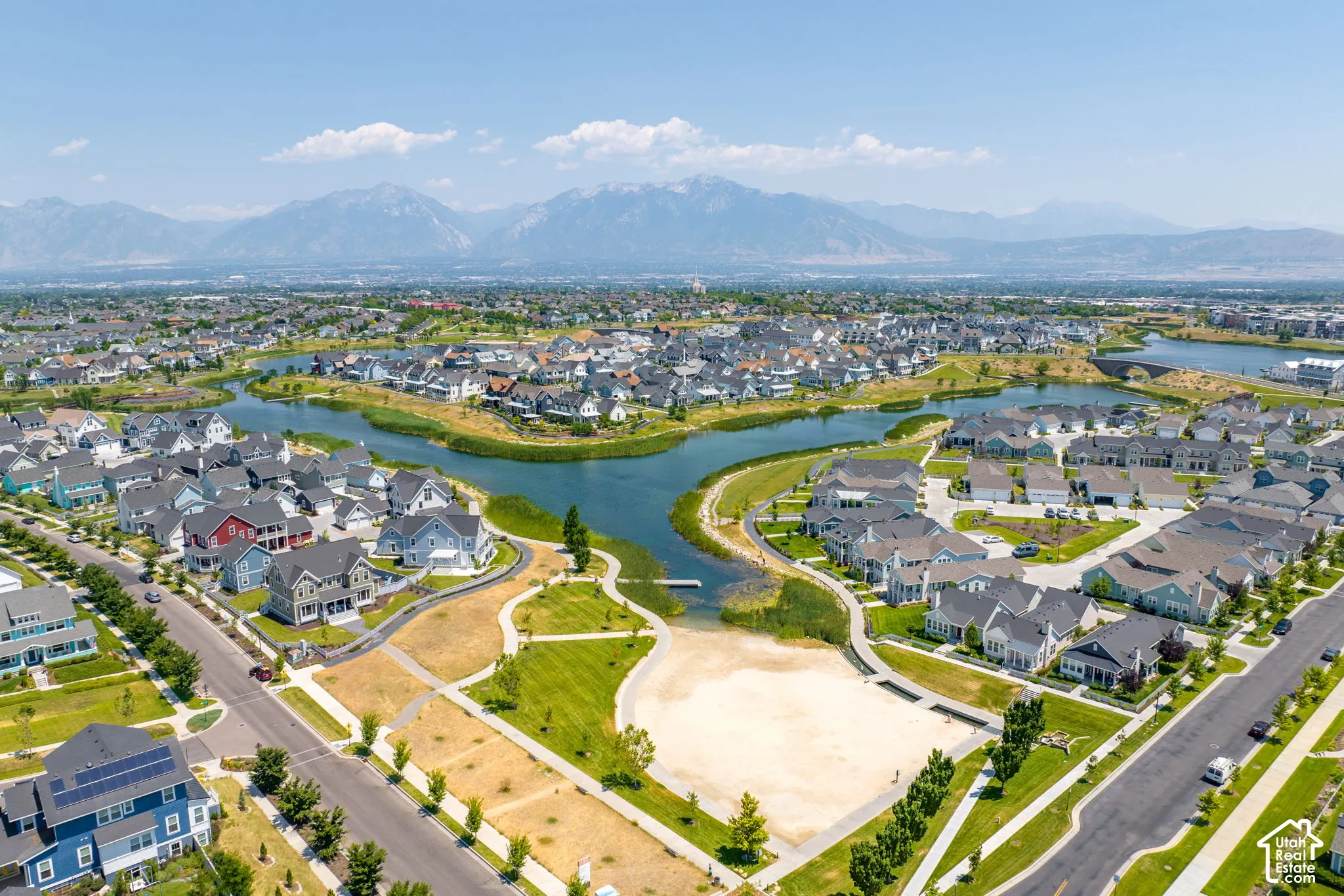 Aerial perspective showcasing a residential community with a central waterway
