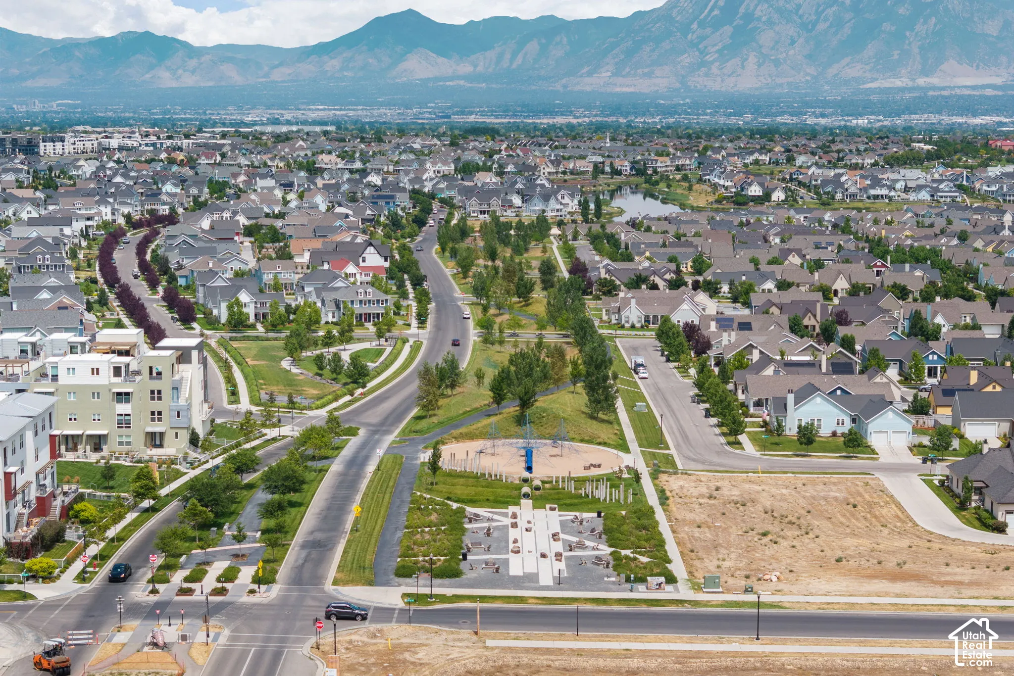 Expansive community featuring diverse residential architecture, mature landscaping, and a mountain backdrop