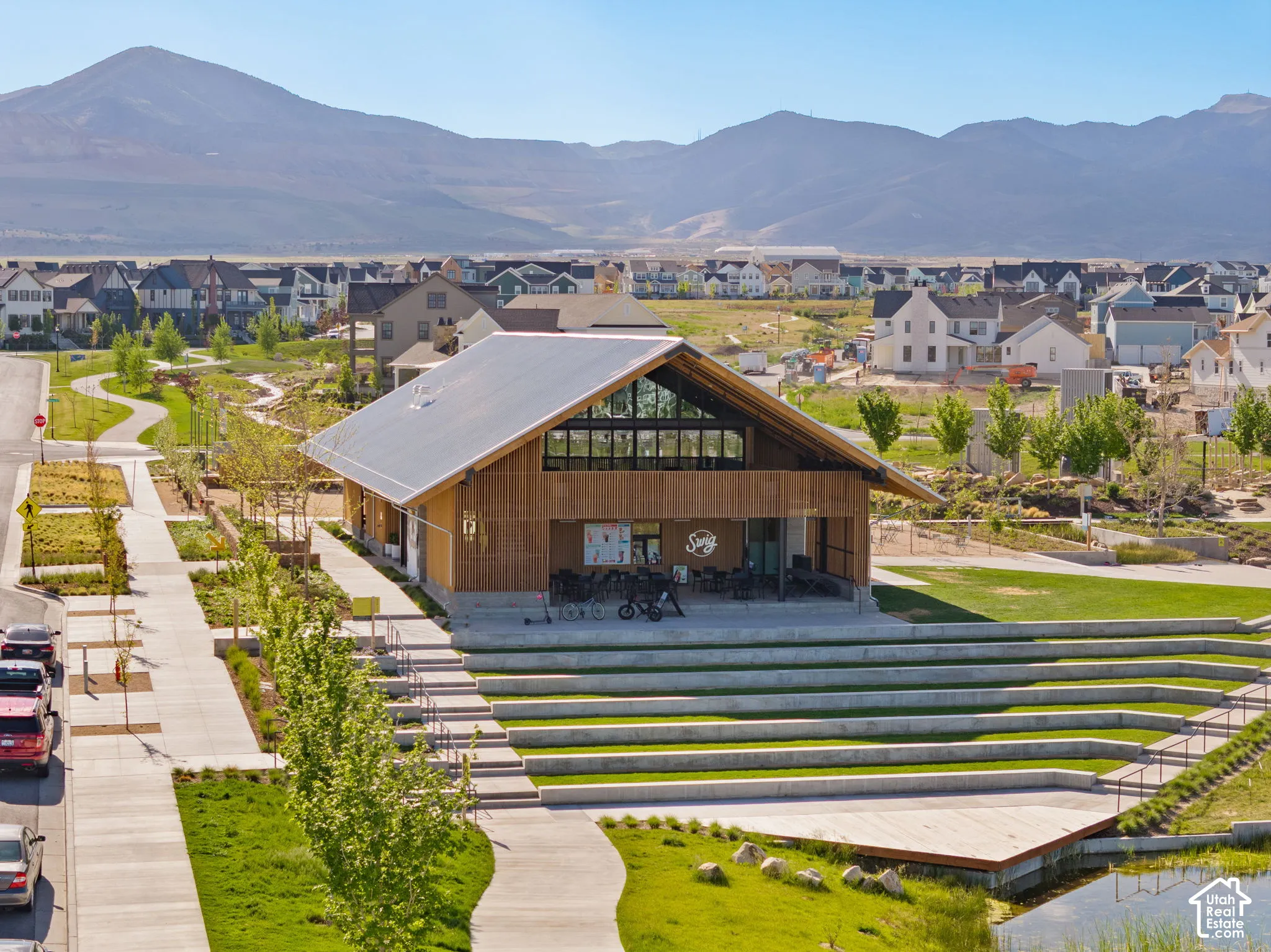 Community building featuring a peaked metal roof, extensive window wall, and wood-finish siding