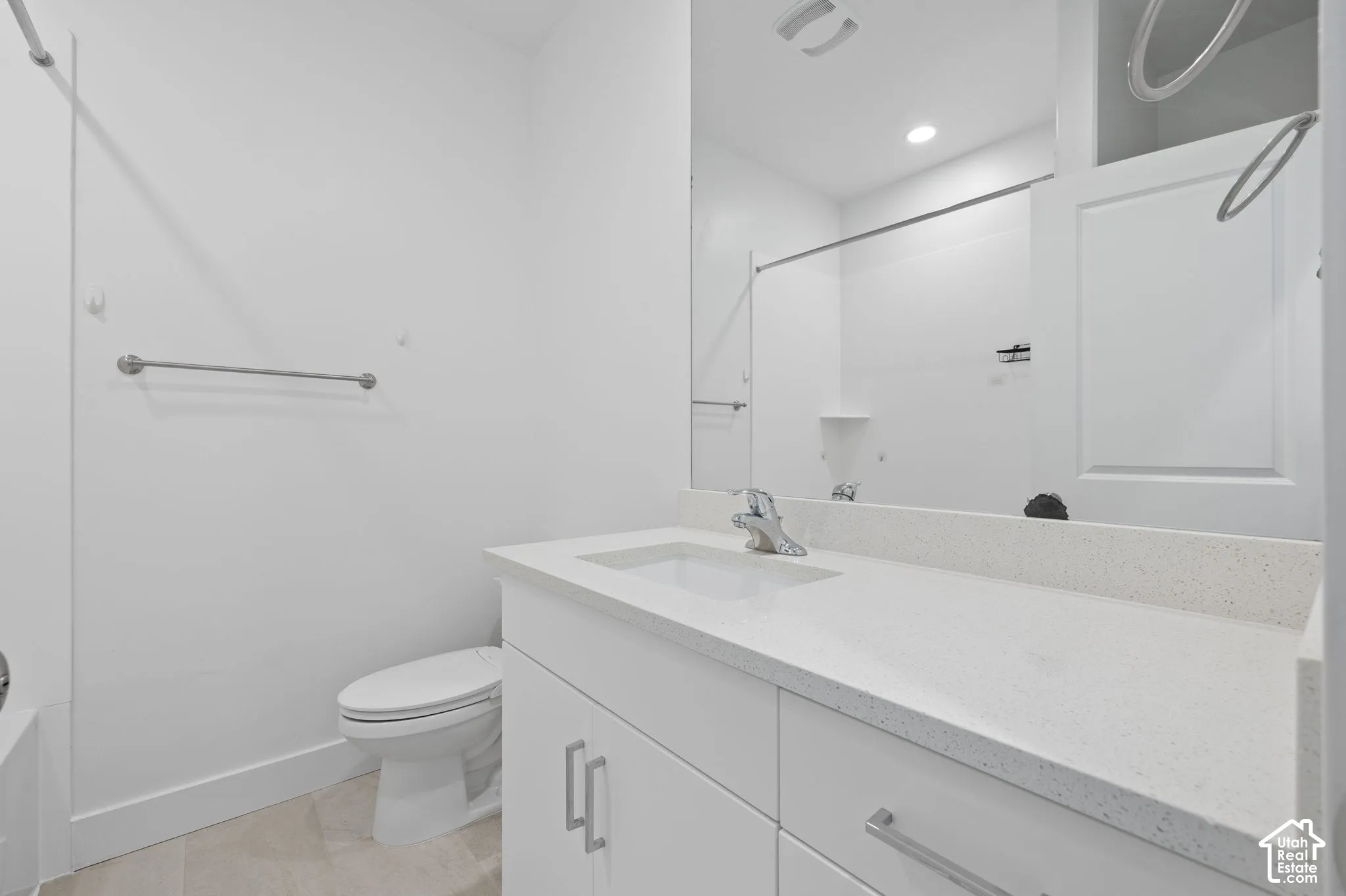 Third floor full bathroom featuring a white vanity with a light-colored quartz countertop, an undermount sink, and a chrome faucet, abundant counter space
