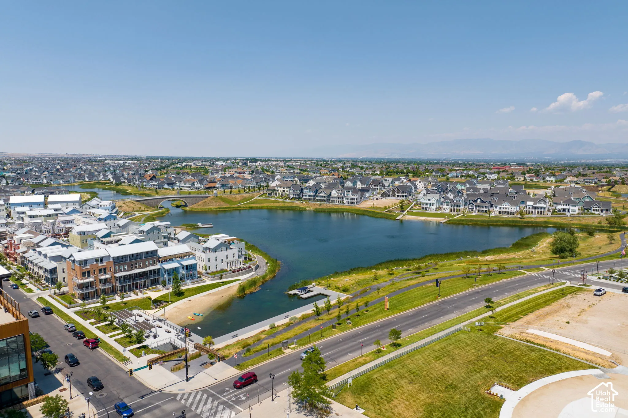 Aerial perspective showcasing a residential area featuring a central lake
