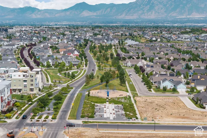 Expansive community featuring diverse residential architecture, mature landscaping, and a mountain backdrop