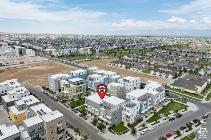 Aerial perspective showcasing a contemporary multi-story building within a residential development