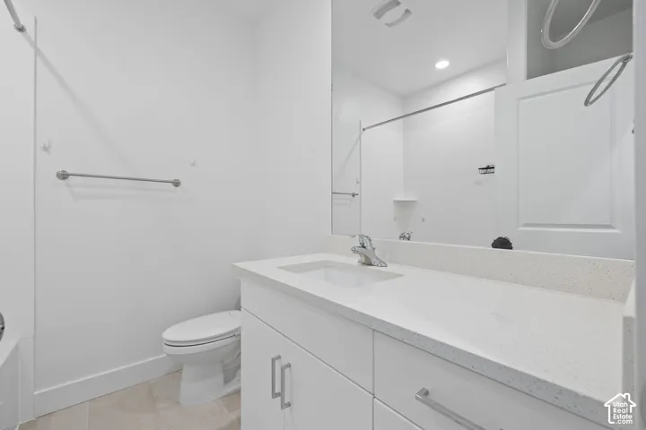 Third floor full bathroom featuring a white vanity with a light-colored quartz countertop, an undermount sink, and a chrome faucet, abundant counter space