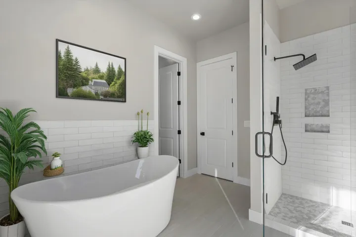 Spa-inspired primary bathroom showcasing a freestanding soaking tub, subway tile surround, walk-in shower with rainfall showerhead and matte black fixtures, polished concrete flooring, and abundant natural light from recessed ceiling fixtures