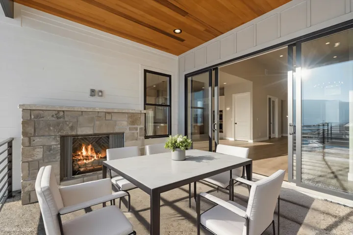 Covered outdoor living space featuring a wood plank ceiling and shiplap wall