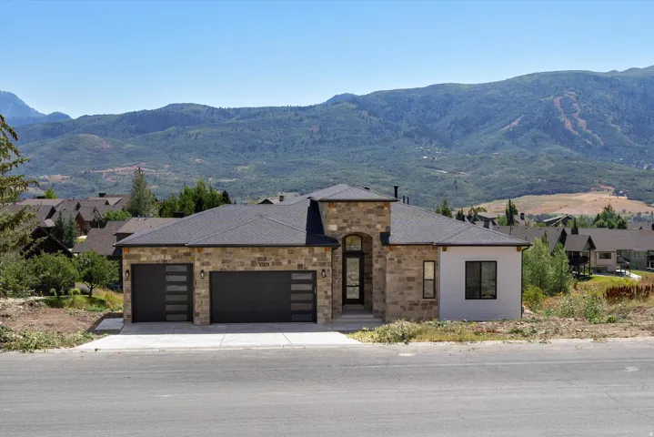 Modern residence featuring a striking stone and stucco exterior with clean architectural lines