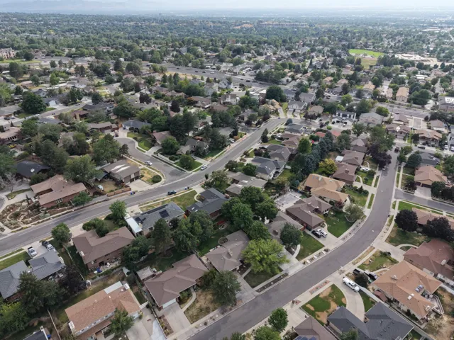 Residential neighborhood featuring mature trees, paved streets, and a variety of architectural styles