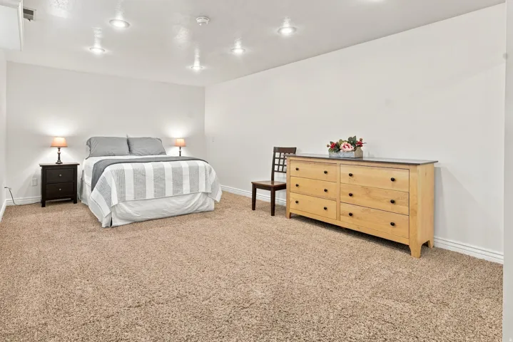 Carpeted room with recessed lighting and neutral wall tones