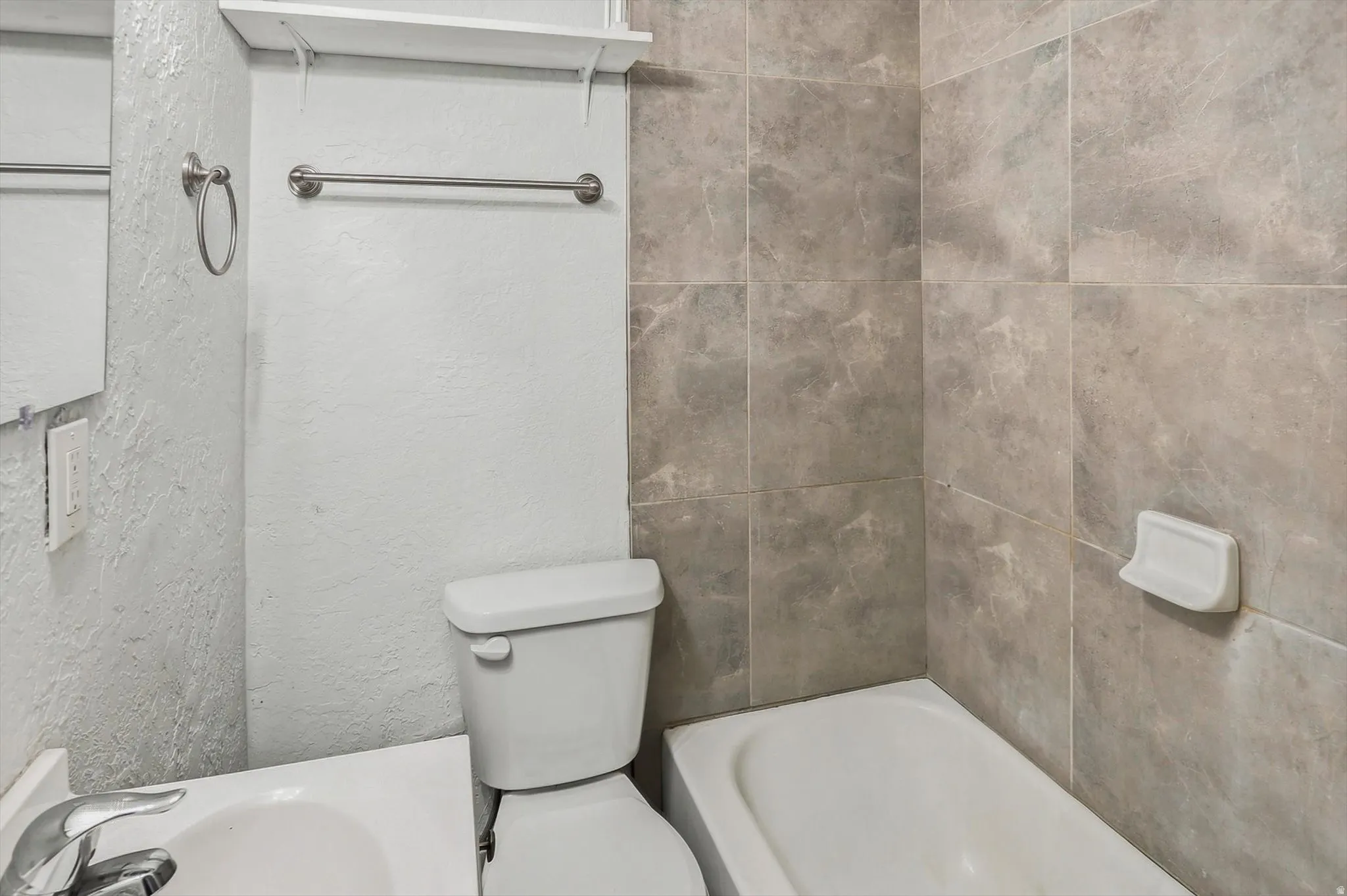 Bathroom with tub and shower compo and vanity with sink